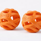 Two orange Chuckit Air Fetch Balls with open design on a white background