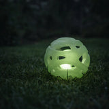 Glow in the dark breathable fetch ball glowing on grass at night