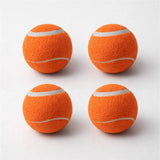 Four orange Chuckit tennis balls arranged on a clean studio background