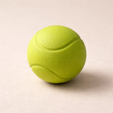 Green tennis ball on a beige background
